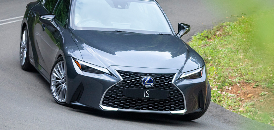 Lexus IS 2021 Model driving down a hill and bend