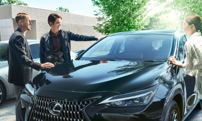3 people gather around a black NX 250.