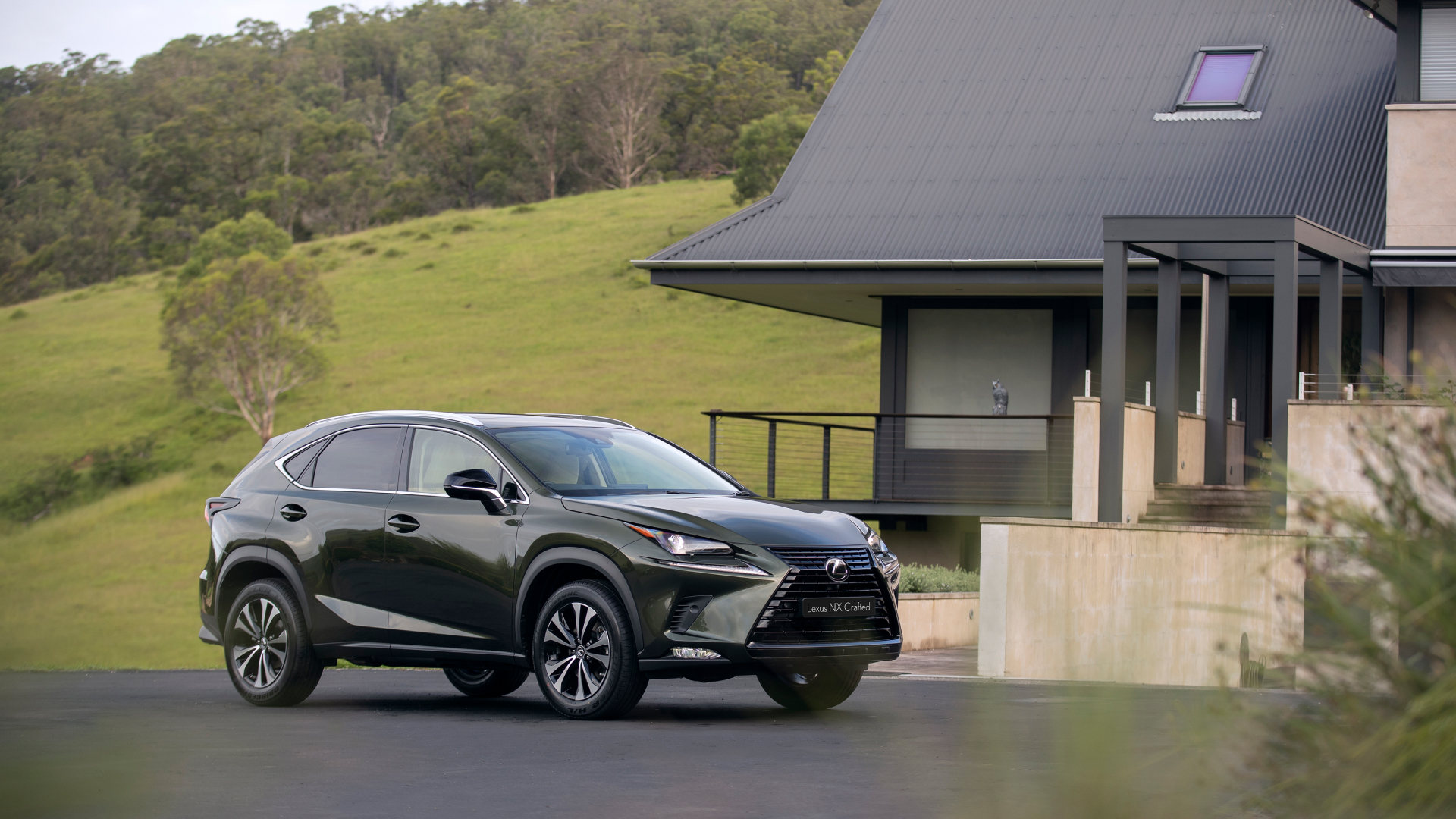 2021 Lexus NX 300 Crafted Edition parked on a road, in front of rolling hills and a house.