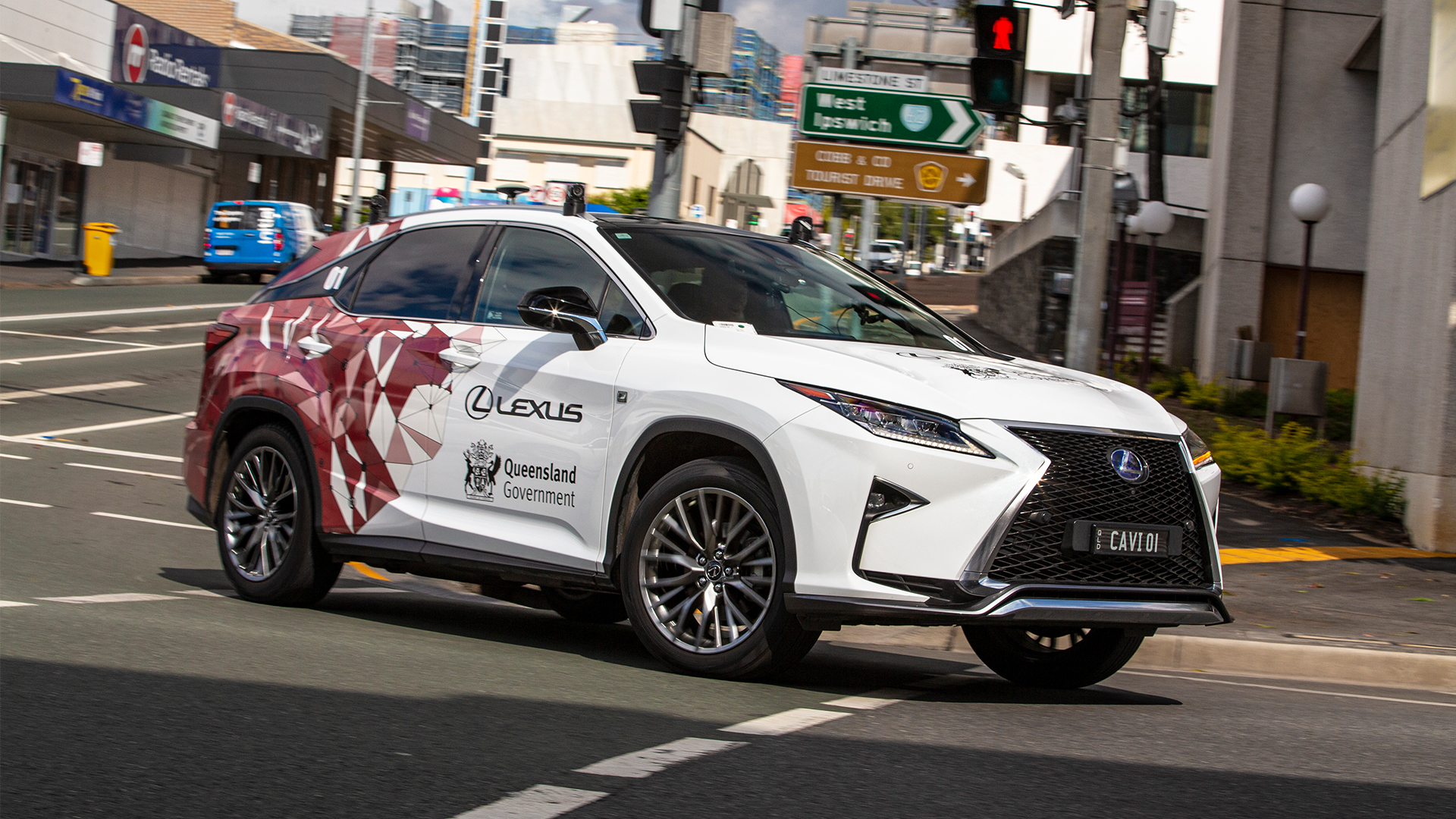 A white Lexus RX with the Queensland Government partnership logo