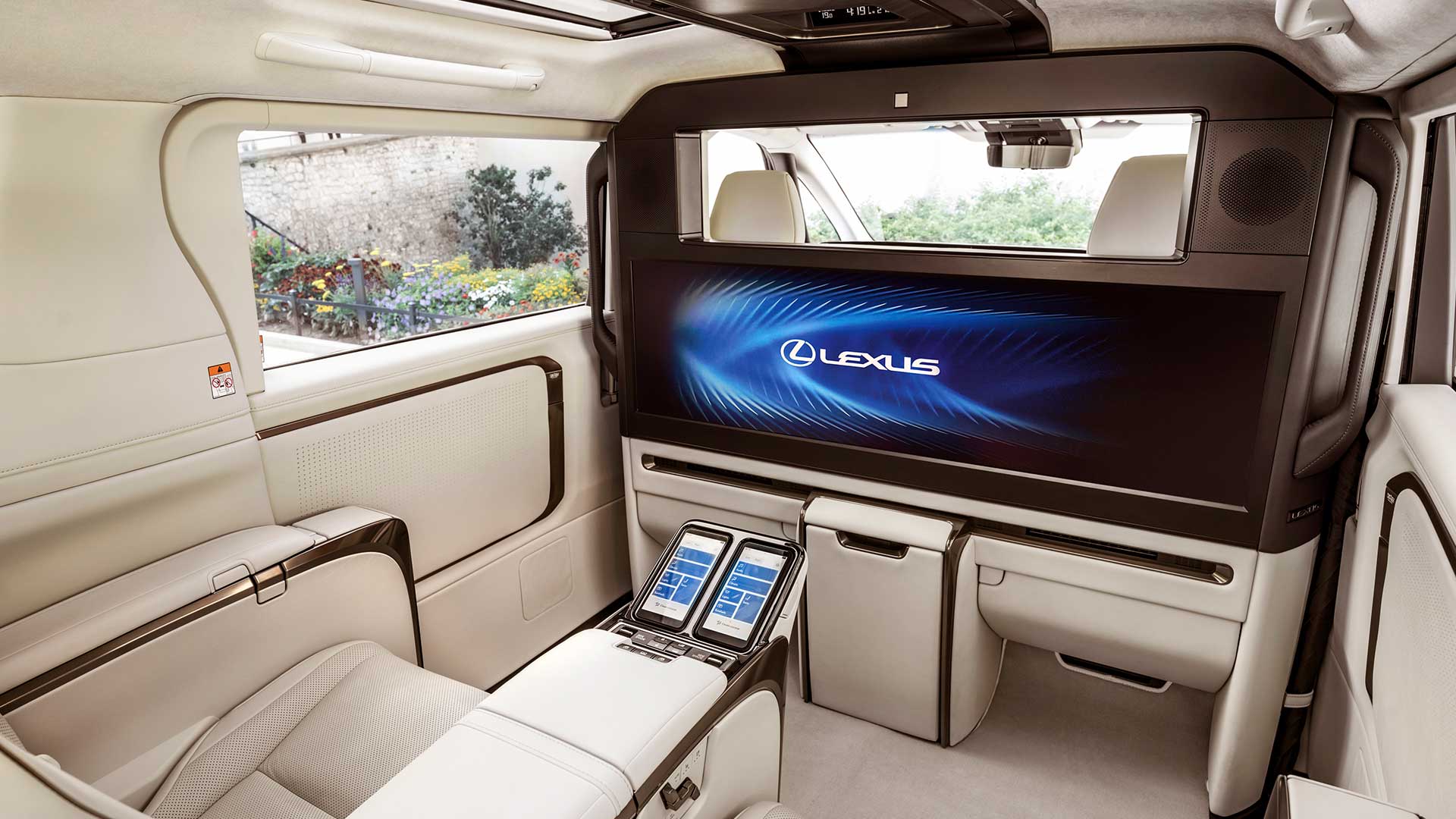 The back seat cabin showing the screen and controls in the Lexus LM 500h Ultra Luxury vehicle