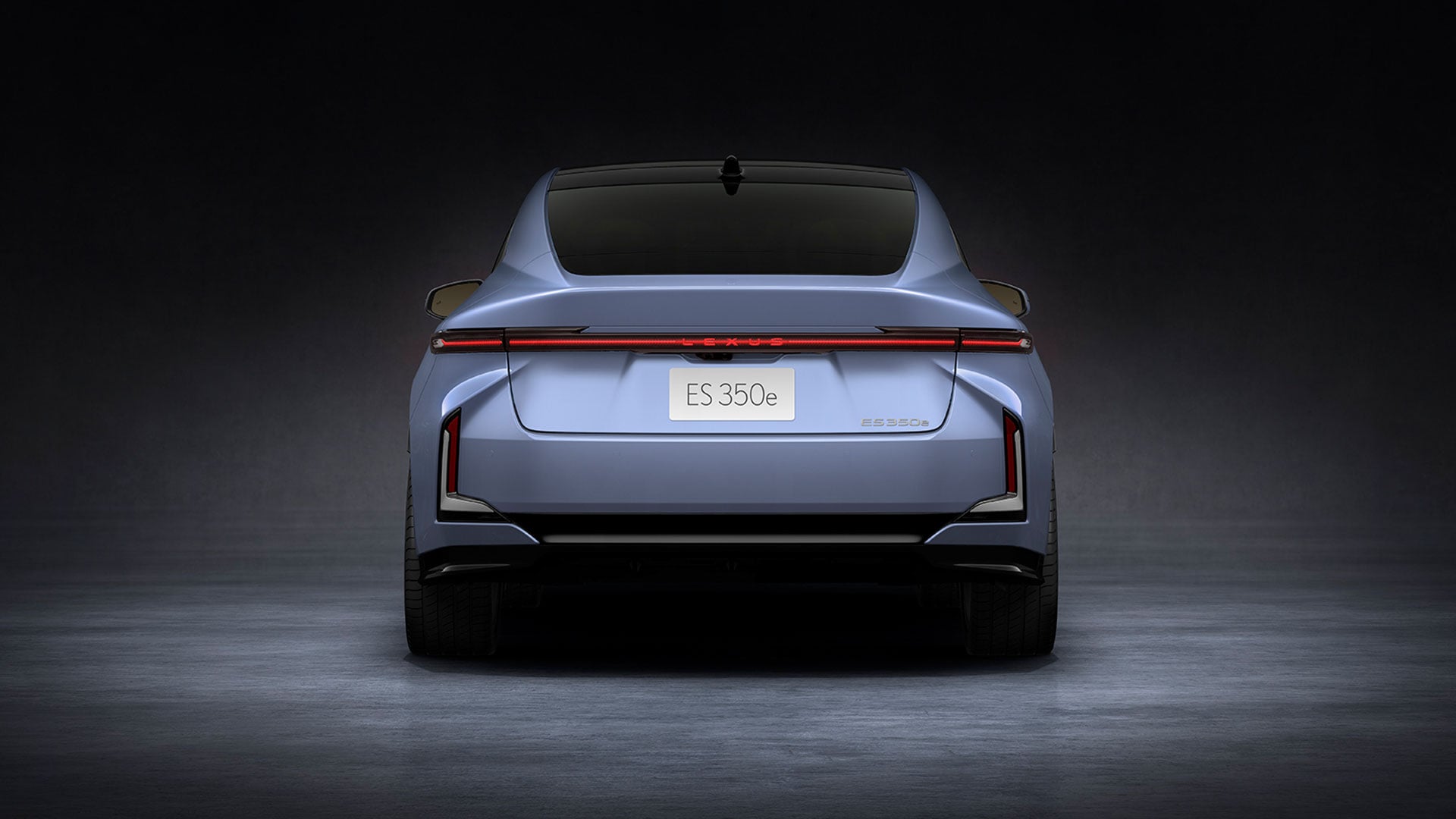 Light blue 2026 Lexus ES 350e all-electric sedan, rear view in studio setting.
