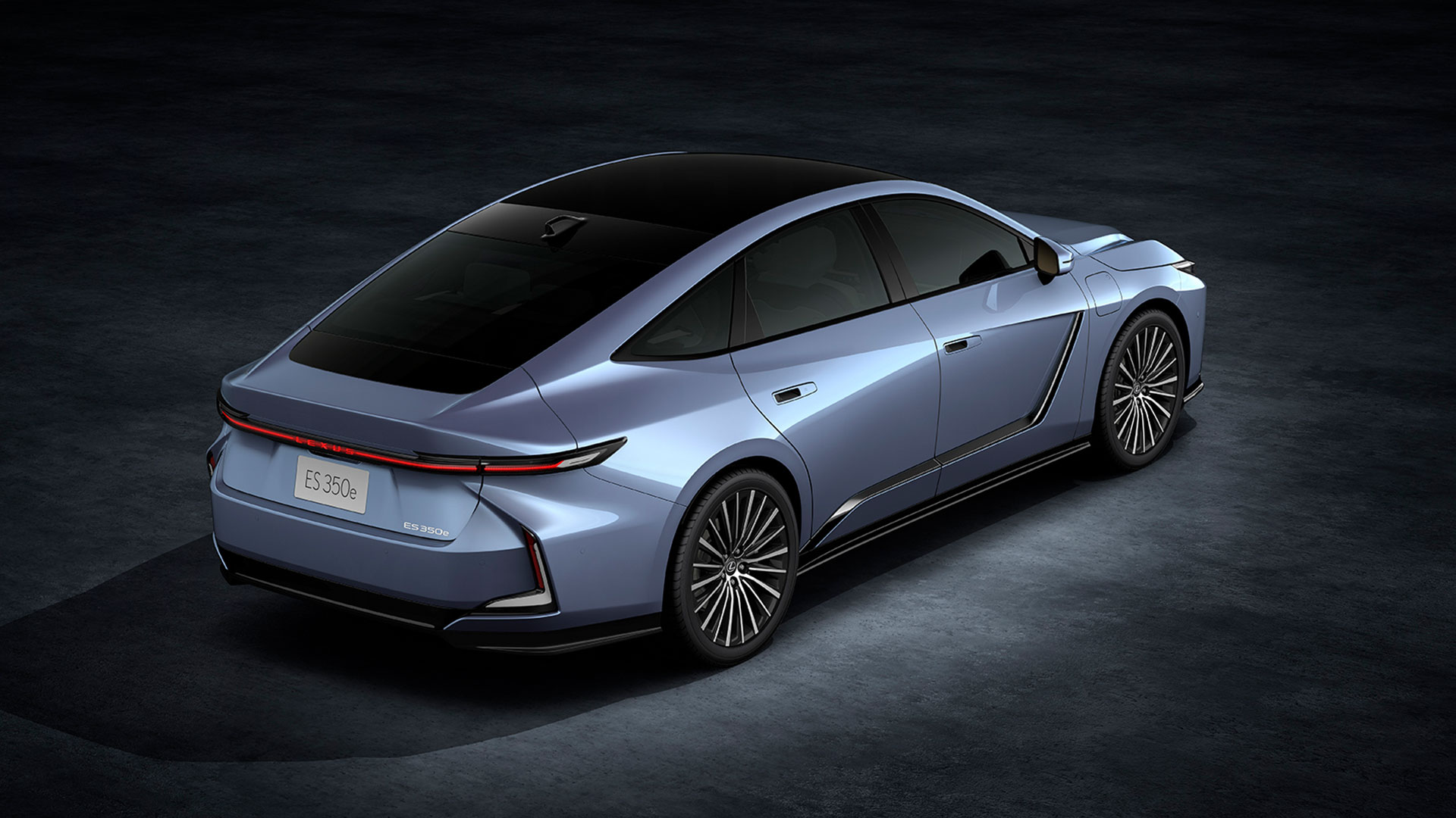 Light blue 2026 Lexus ES 350e all-electric sedan, rear view in studio setting.