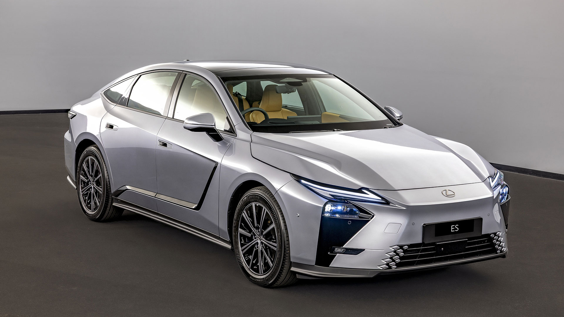 The Lexus ES luxury sedan in silver in a studio setting